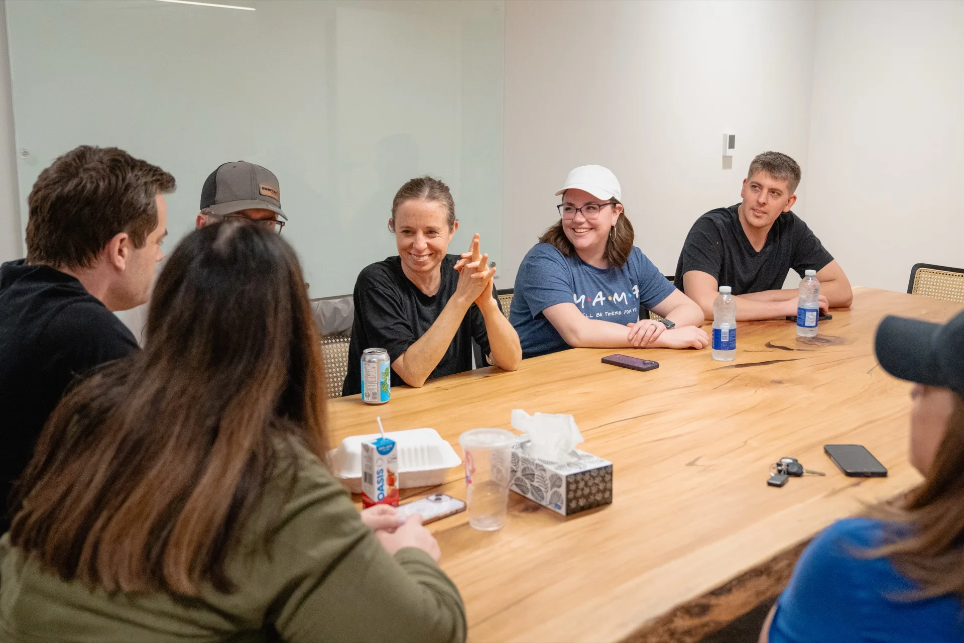 A group of adults sitting around a table in conversation.