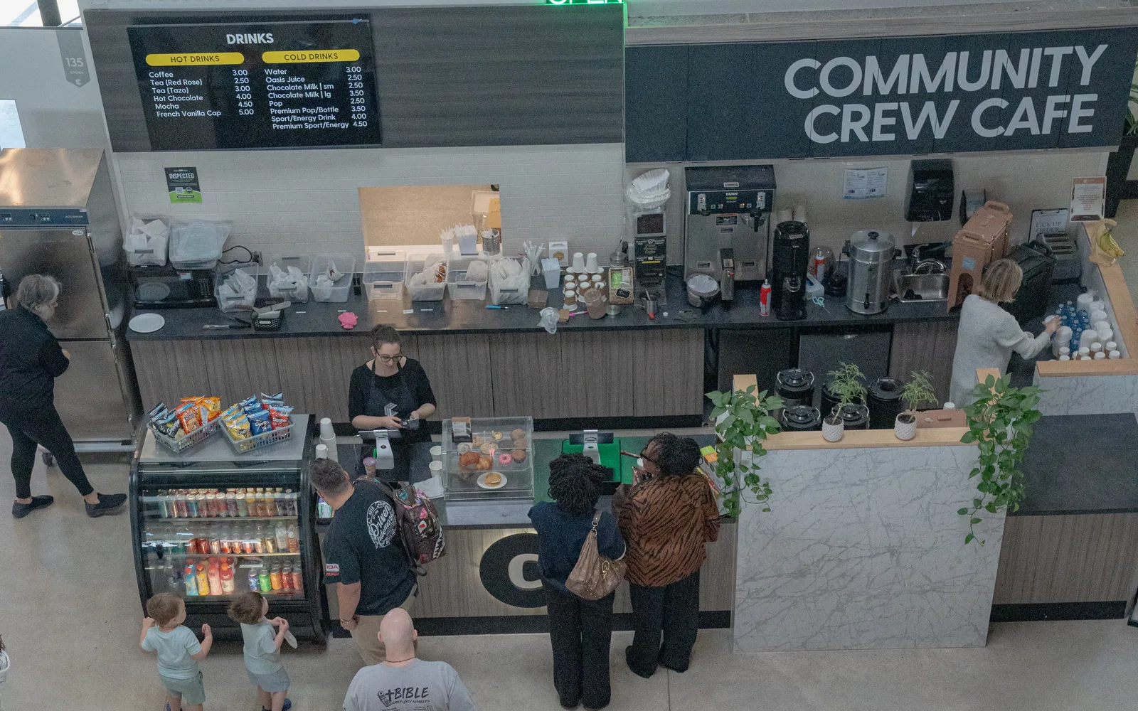 The cafe team serving guests at the counter on a Sunday morning.