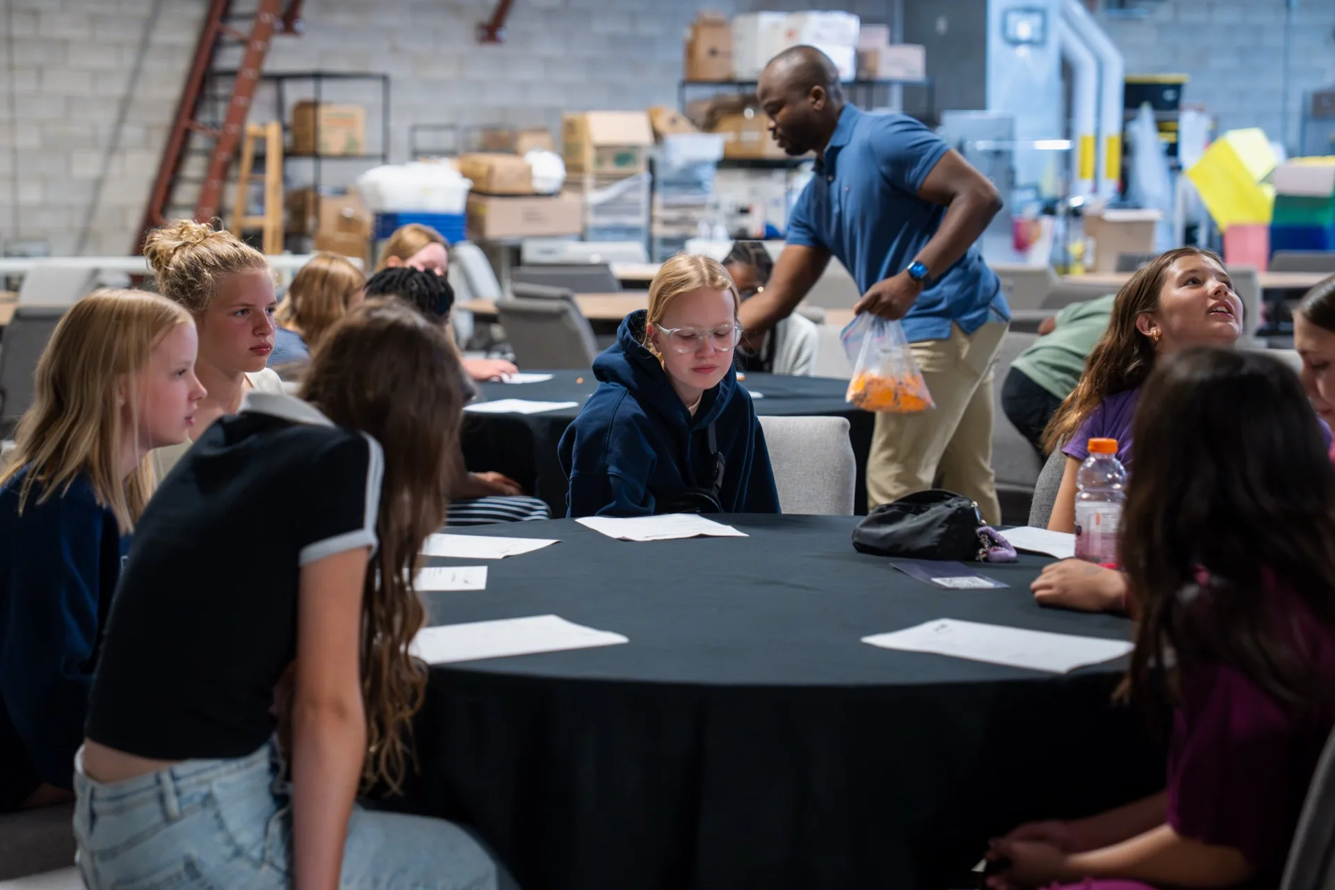 Jr. Youth students sitting at round tables with a leader.